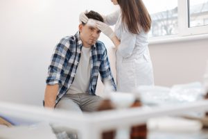 Oklahoma Premises Liability Lawyers 4 doctor checks man with head injury after slip and fall accident