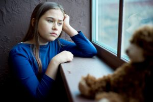 depressed girl as photo illustration of suspected child abuse