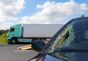 View of truck in an accident with a shattered car windshield