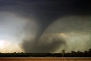 An F3 tornado sets down in a field.