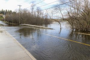 Water covering a flooded road. 