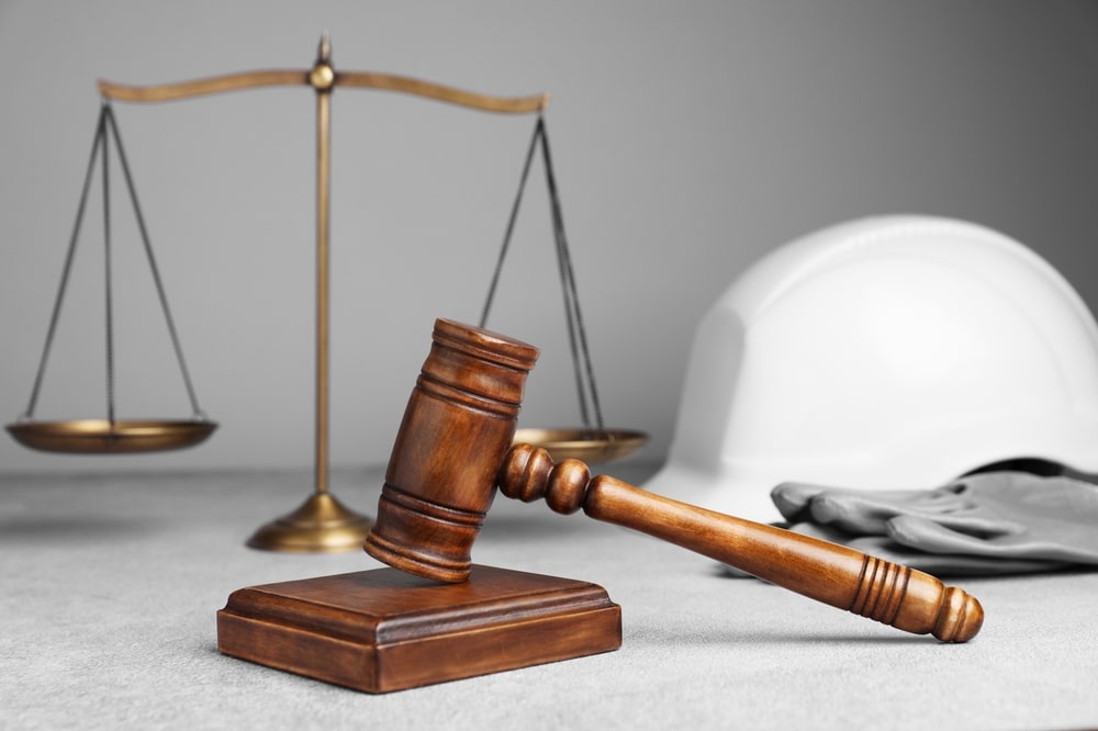 Oklahoma Workers’ Compensation Lawyers 4 Gavel, scales of justice, and hard hat symbolizing workplace injury and legal protection