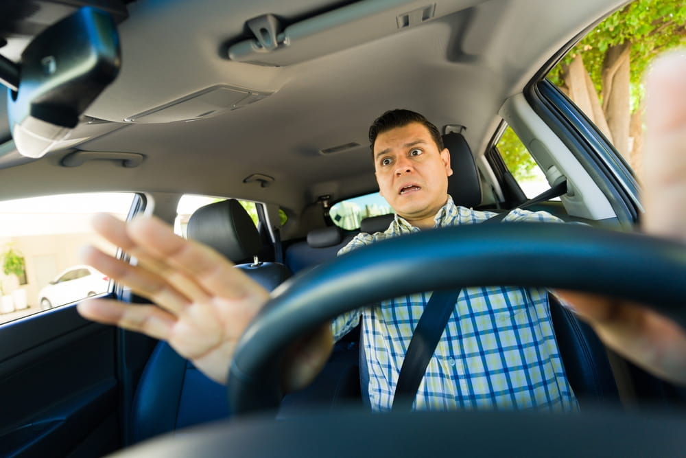 Driver reacting suddenly to avoid collision during potential car accident