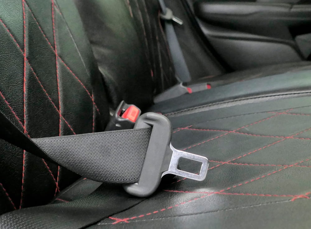 Unfastened seatbelt inside vehicle highlighting risk during car accident