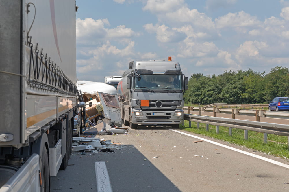 Multi-vehicle truck accident on a highway showing severe collision damage involving commercial trucks