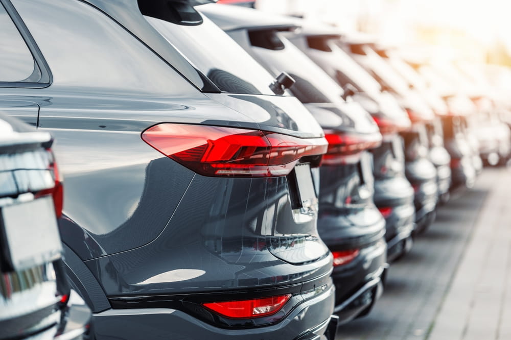 Row of rental cars parked in a lot representing rental car insurance coverage and liability in Oklahoma