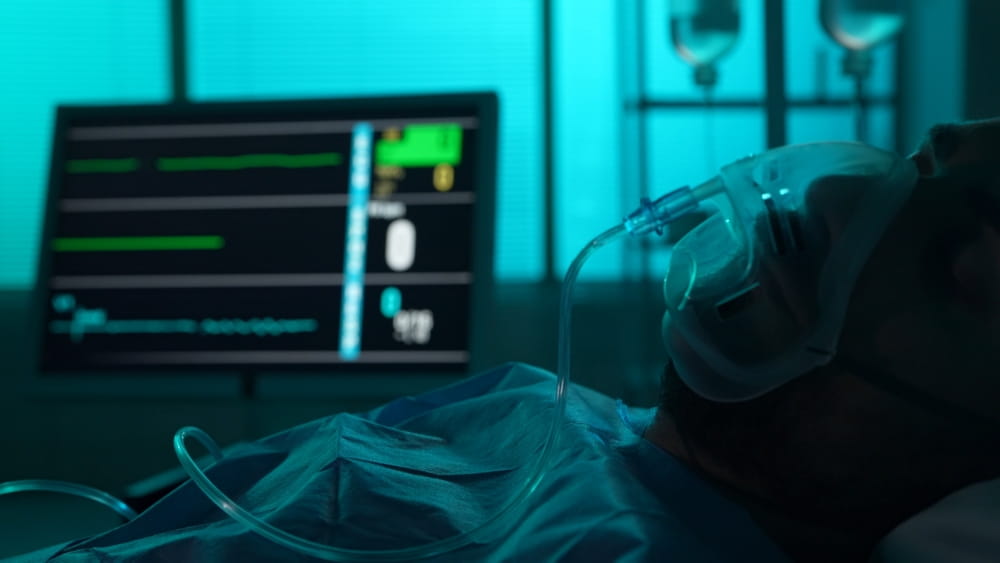 Patient receiving hospital treatment after a traumatic brain injury with oxygen support and monitoring equipment